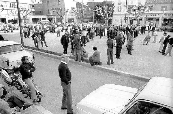 Frenchmen play Boules in the streets of Poussan, France. April 1975 75-2097-001