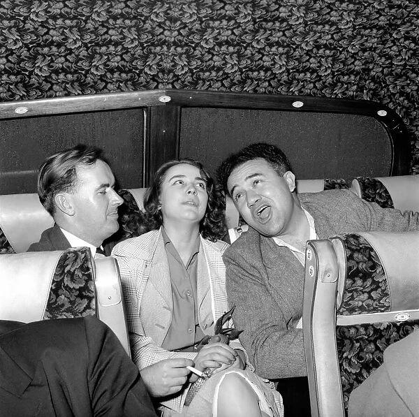 Friends enjoying a joke and a laugh on a coach trip to Manchester. July 1955 A322-005