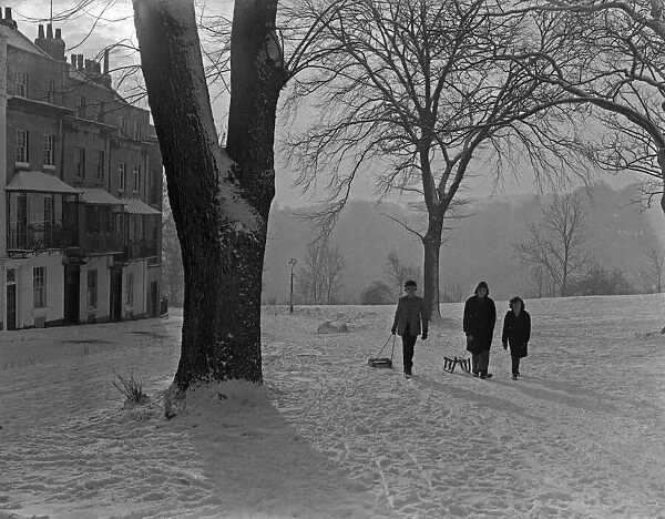 Friends pulling their sledges up Sion Hill, Clifton, Bristol. 1st January 1962