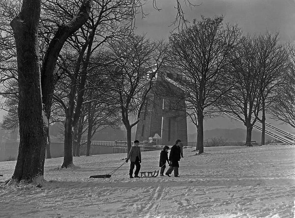 Friends pulling their sledges up Sion Hill, Clifton, Bristol. 1st January 1962