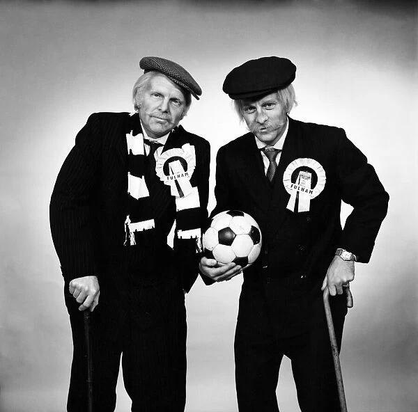 Fulham footballers Bobby Moore (left) and Alan Mullery dressed in suits and make-up