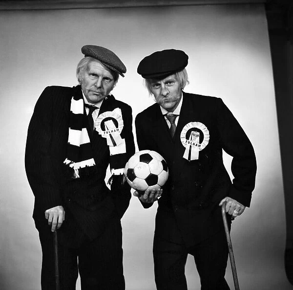 Fulham footballers Bobby Moore (left) and Alan Mullery dressed in suits and make-up