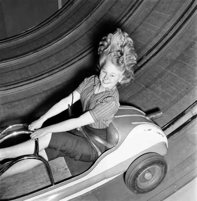 Framed Print : Fun fair - Jean Baker on one of the rides at the festival gardens Battersea. April 1953