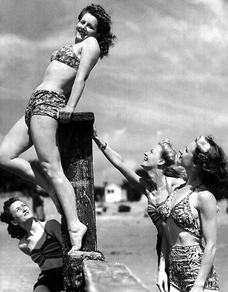 Fun in the sun, August 1946 4 young women play around on the beach in the summer