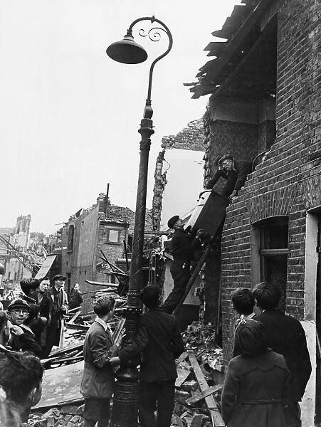 Furniture being removed from a bombed house in Bethnal Green during Second World War