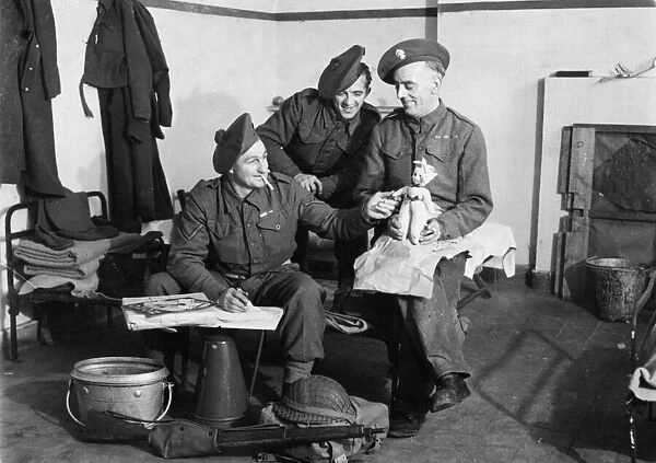 Fusilier F. Walsh of Grosvenor Avenue, London packs a doll which he bought in Brussels