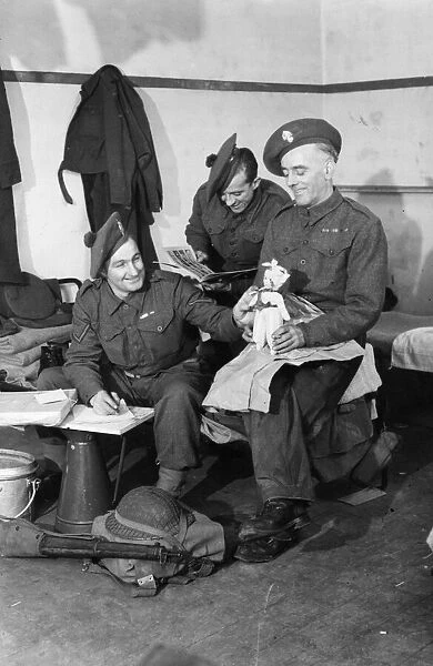 Fusilier F. Walsh of Grosvenor Avenue, London packs a doll which he bought in Brussels