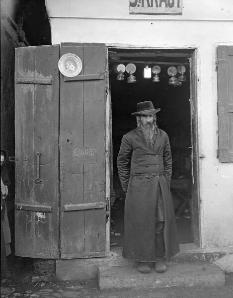 Galician trader seen here standing in the entrance to his Lamp shop in Halicz