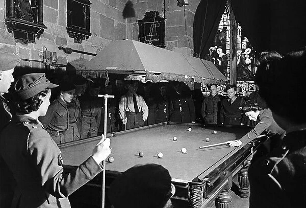 A game of snooker under a stained glass window in St Helens Church Worcester gives troops
