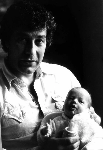 Gareth Hunt in June 1980 with 5 week old baby Oliver at their home in Effingham, Surrey