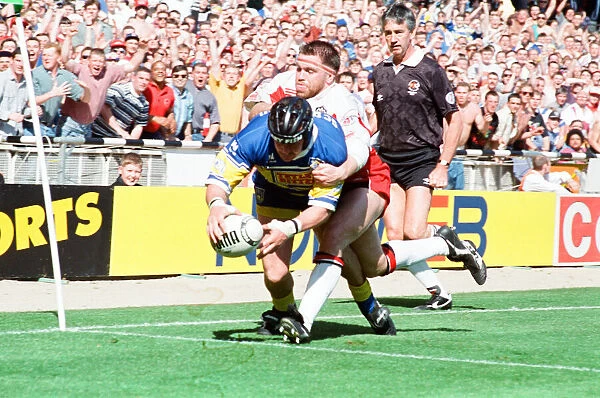 Garry Schofield avoids the Wigan defence to score a try for Leeds during the Rugby