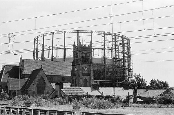 Garston Gasometer, dwarfs church in foreground, Liverpool, Merseyside, 16th August 1988