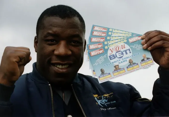 Framed Print : Gary Mason Boxing Heavywieght boxer holding up Daily Mirror You Bet game cards Framed Print : Gary Mason Boxing Heavywieght boxer holding up Daily Mirror You Bet game cards