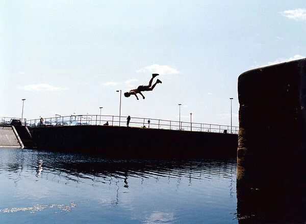 Gary Smith cools off with a dive into the dock, Albert Dock, Liverpool, Merseyside