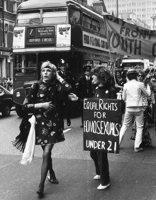 Framed Print : Gay Liberation March in Oxford Street Ginger a male walking past youth with placard Framed Print : Gay Liberation March in Oxford Street Ginger a male walking past youth with placard