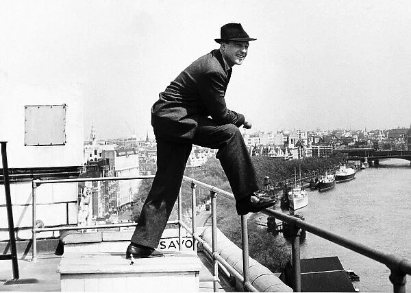 Gene Kelly Actor Entertainer admires the Thames from his hotel roof Dbase MSI