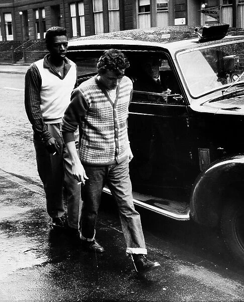 Gene Vincent pop singer 1960 beside taxi arriving back at hotel after being rushed to