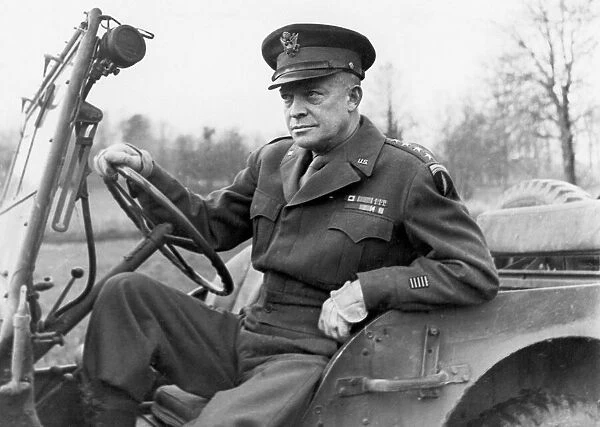 General Dwight D Eisenhower seated in a jeep on his way to deliver his Christmas message