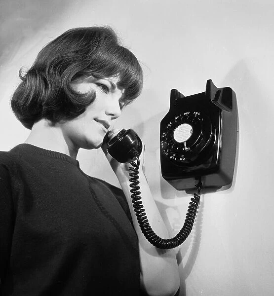 A General Post Office official talking on the telephone. 16th April 1963