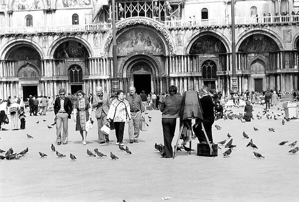 General scenes in Venice. Tourist walk past a photographer using a old style glass plate