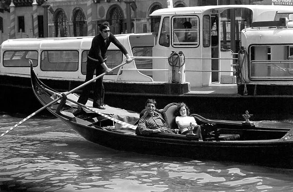 General scenes in Venice. A young couple take a gondola along the Grand Canal