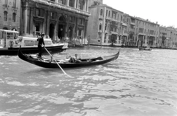 General scenes in Venice. A young couple take a gondola along the Grand Canal
