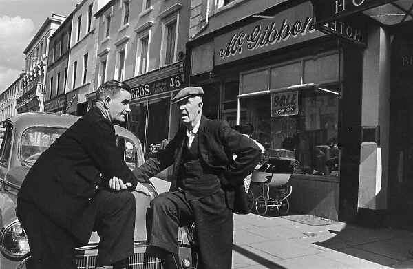 To gentlemen seen here outside the main parade of shops in Lurgan