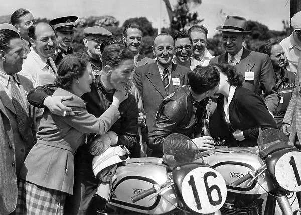 Geoff Duke (the winner) receives a congratulatory kiss from his wife Pat while the 2nd H