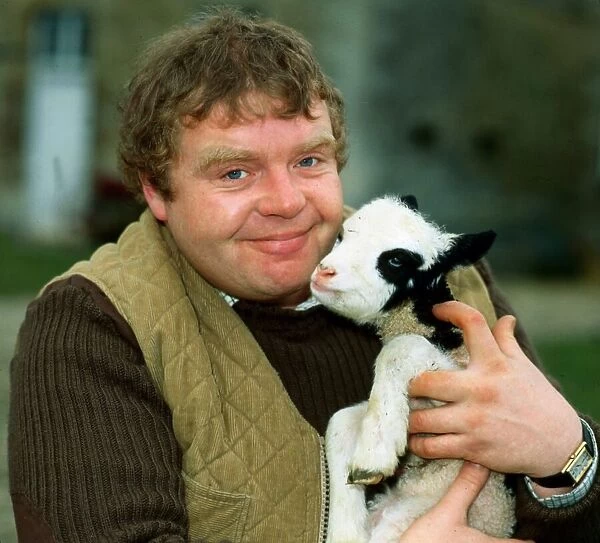 Geoffrey Hughes holding baby goat April 1982