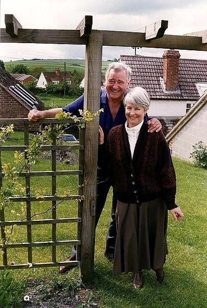 George Baker standing next to a gate with wife louie