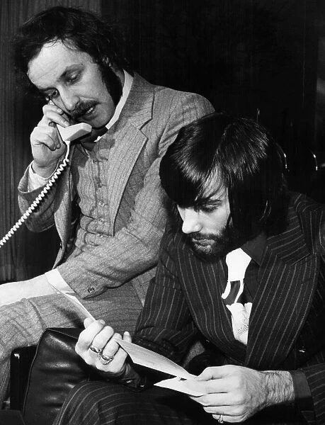 George Best and his business partner Malcolm Mooney working at Bests home
