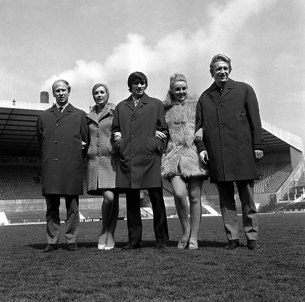 George Best centre with Bobby Charlton and Denis Law 1967 pose with two models at Old