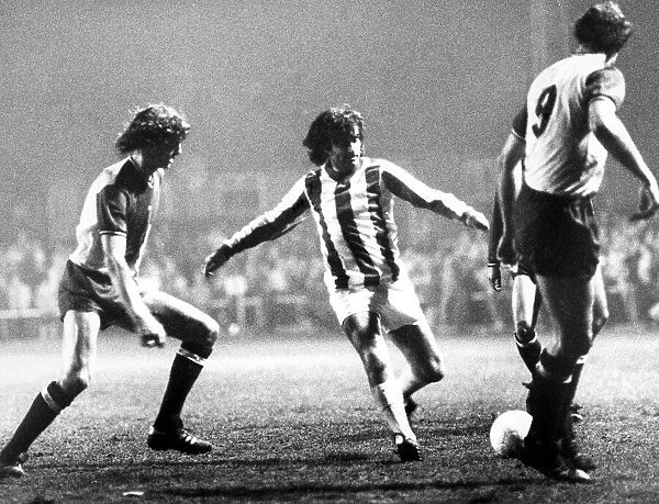 George Best dribbles the ball between Coventry defenders Garry Gillespie(left