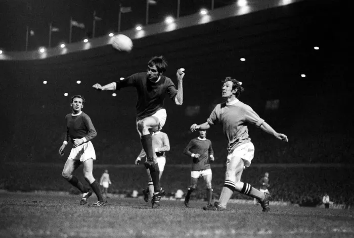 Framed Print : George Best heads the ball clear December 1969 watched by Pat Crerand