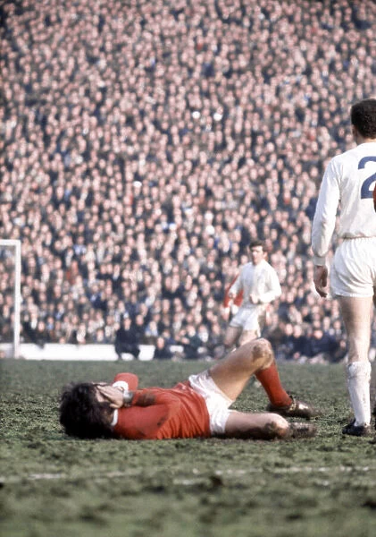 George Best of Manchester United lies on the ground injured during the FA Cup Semi Final