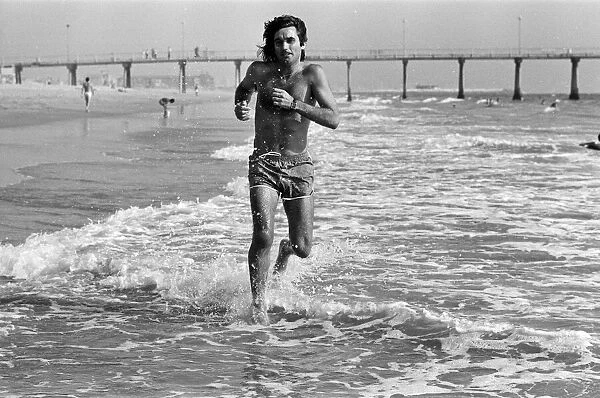 George Best putting in extra training running through the surf and sand at Hermosa Beach