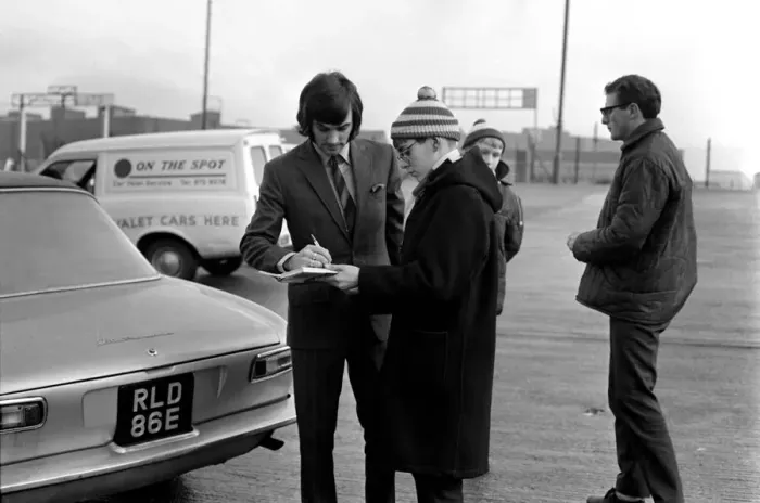 Framed Print : George Best signs autographs and boards the coach at Old Trafford he has just been fined Framed Print : George Best signs autographs and boards the coach at Old Trafford he has just been fined
