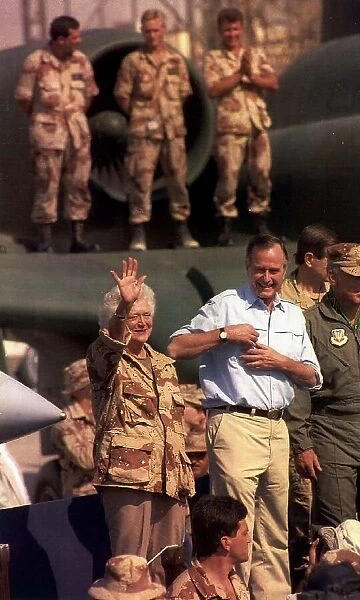 George Bush President of the United States with his wife Barbara waving to American army