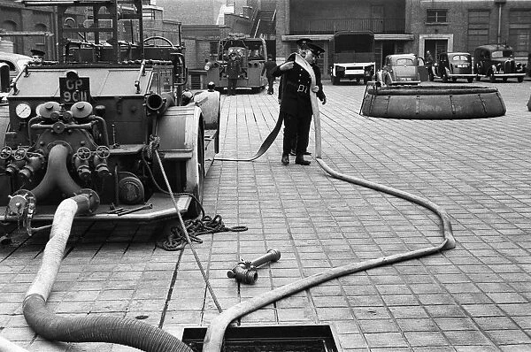 George Greenwell carrying hose with Station Officer Harding seen here during pump