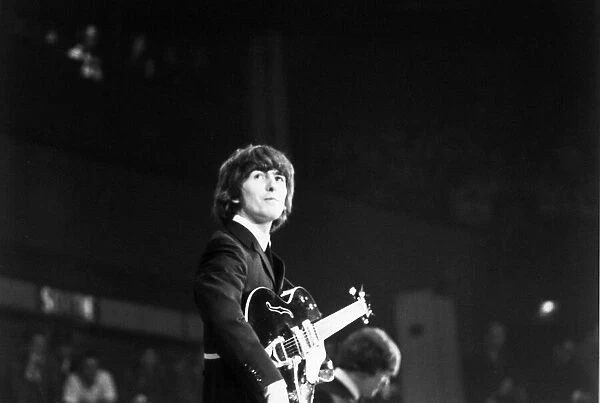 George Harrison of The Beatles on stage at the Palais des Sport in Paris. June 1965