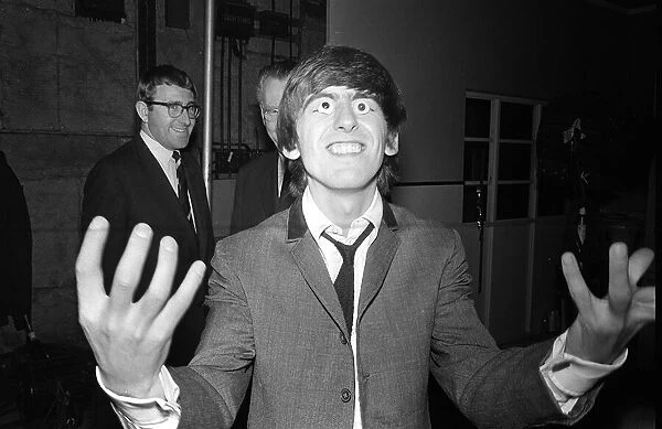 George Harrison with glass eyes when the Beatles details were being taken for their