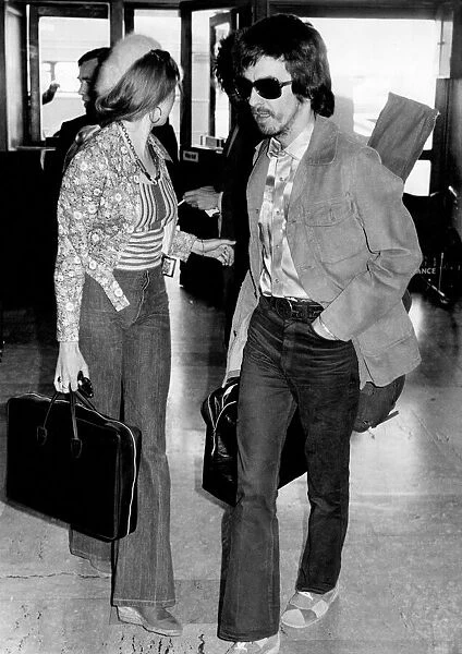 George Harrison at Heathrow Airport today with his wife Patti Boyd. November 1973 P003740