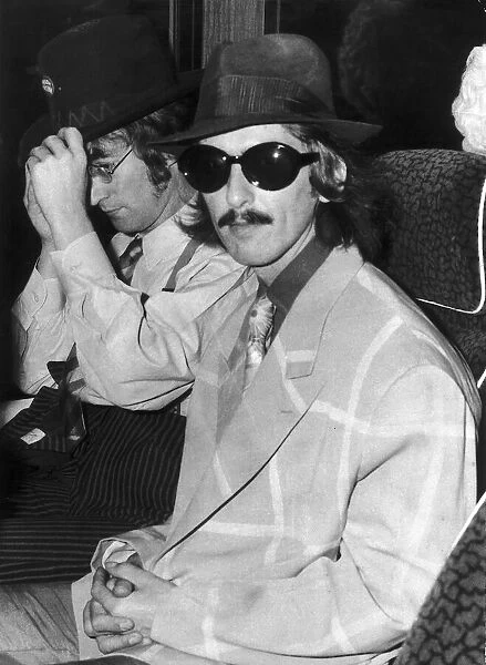 George Harrison and John Lennon as The Beatles set out on their celebrated tour of