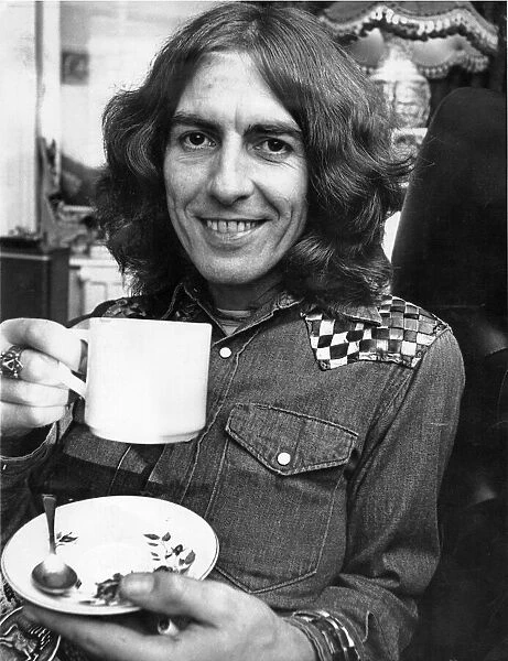 George Harrison, once a member of The Beatles, pictured having a cup of tea in Warrington