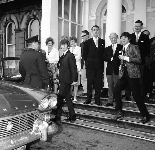 George Harrison and Paul McCartney of The Beatles leaving the Imperial Hotel