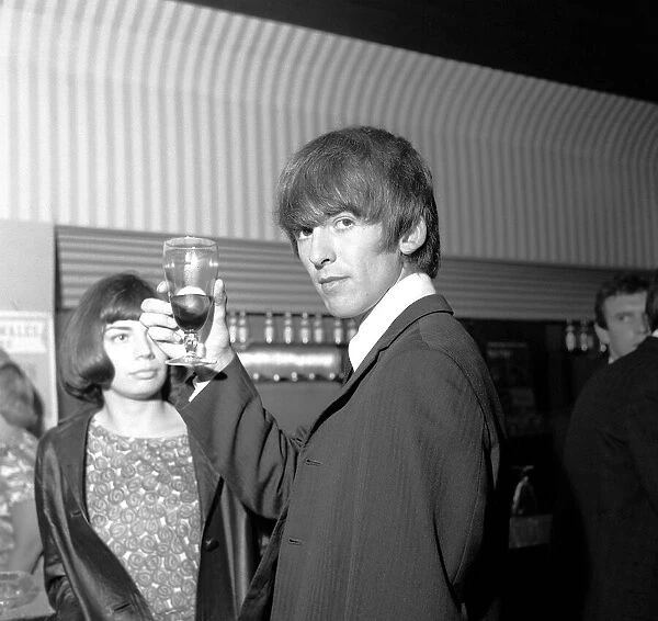 George Harrison raises his glass at the Prince of Wales Theatre, Leicester Square