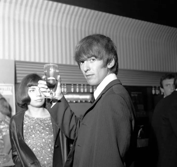 Framed Print : George Harrison raises his glass at the Prince of Wales Theatre, Leicester Square