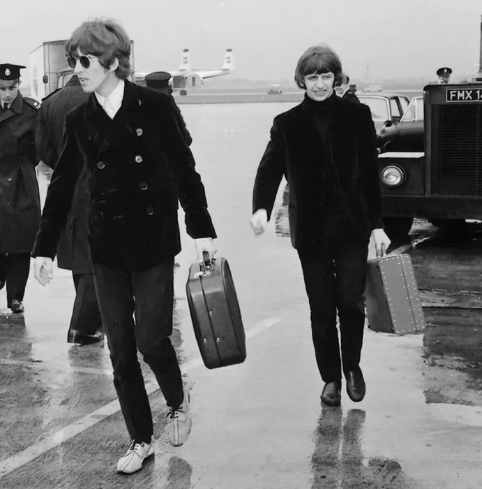 Framed Print : George Harrison and Ringo Starr leave a rainsoaked London Airport for Chicago via Boston