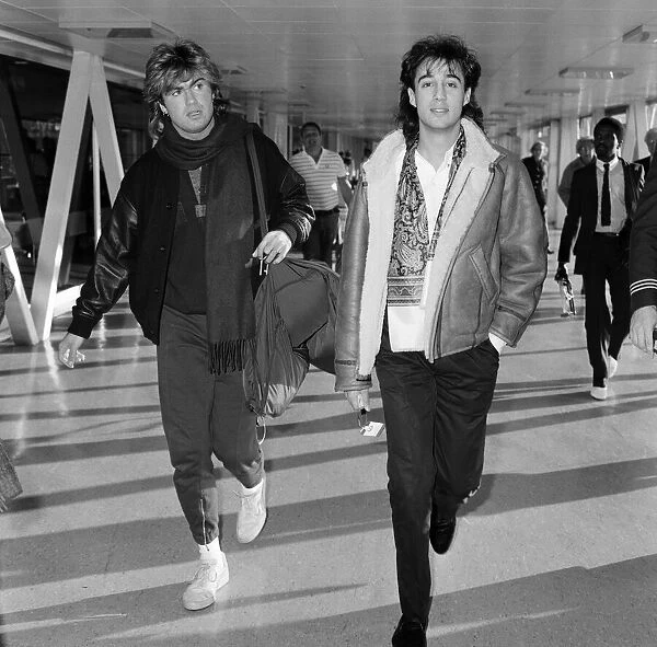 George Michael and Andrew Ridgeley of the pop group Wham!, arriving at Heathrow airport