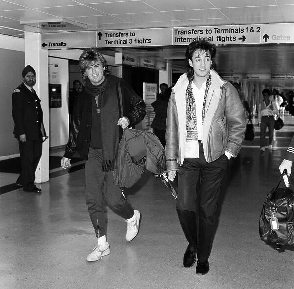 George Michael and Andrew Ridgeley of the pop group Wham!, arriving at Heathrow airport